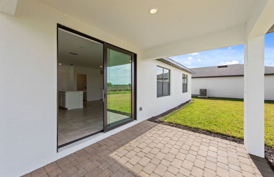 Exterior details and patio area of a home in Whispering Lakes, Lehigh Acres (Image 3).