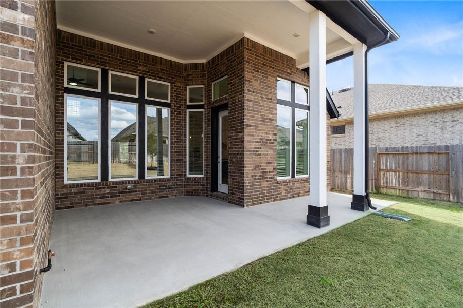 Step outside to the covered rear patio, the perfect extension of your indoor living space for year-round enjoyment.