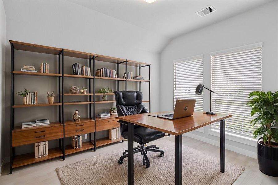 Nestled away quietly in the front of the home is the handsome and grand home office! Featuring high ceilings, lighting, custom paint, plush carpet flooring, and large windows with privacy blinds!