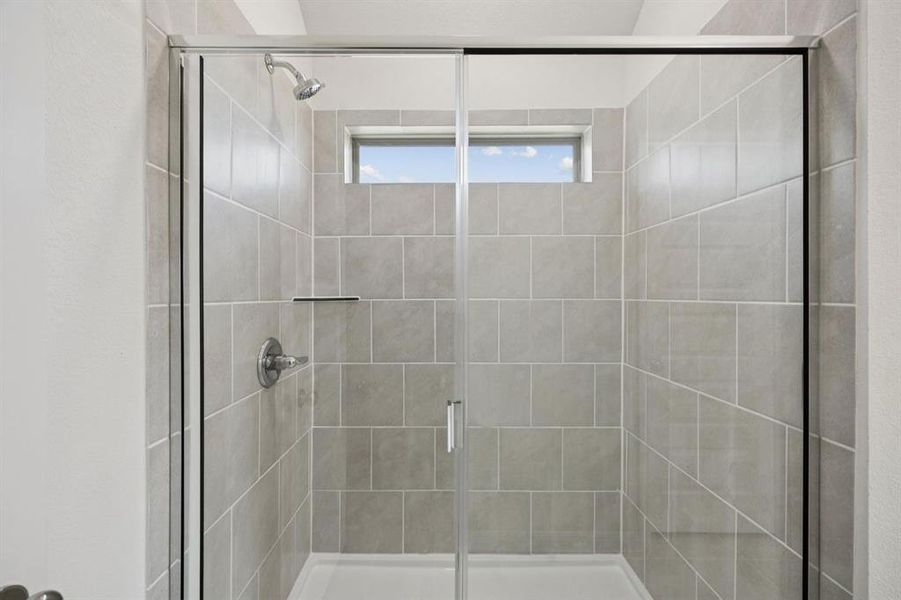 Primary Bathroom in the Cypress home plan by Trophy Signature Homes - REPRESENTATIVE PHOTO