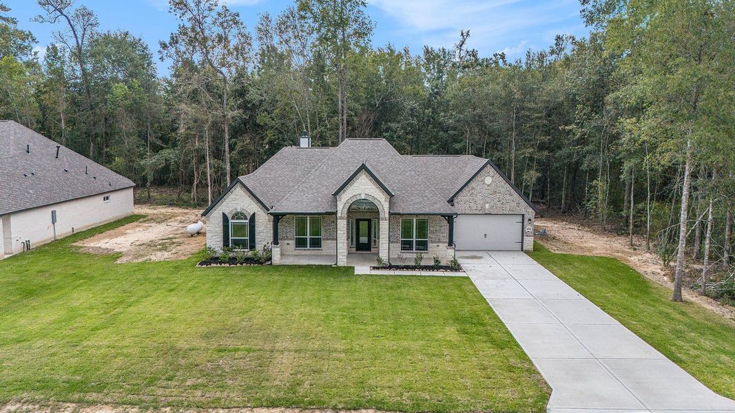 Front exterior of a new home in Encino Estates, Dayton, TX, highlighting curb appeal (Image 20).