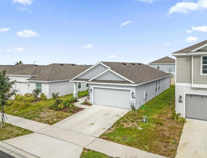Front exterior of a new home in Lawson Dunes, Haines City, FL, highlighting curb appeal (Image 17).