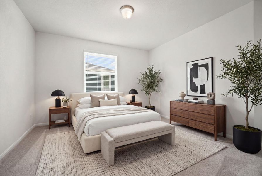 Soft carpet and clean walls define this peaceful bedroom with high ceilings.