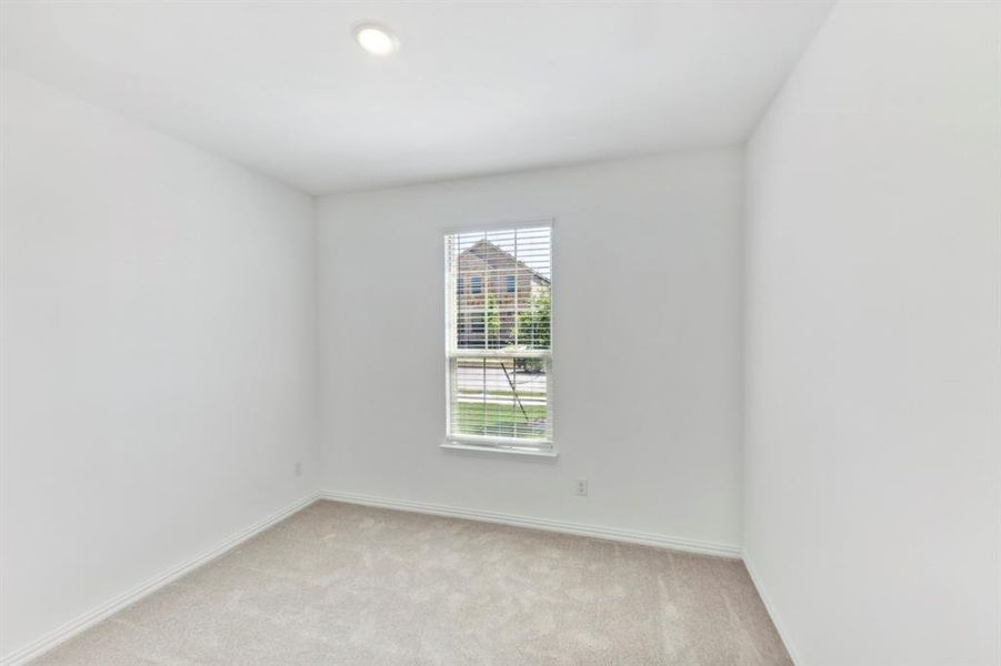 Unfurnished room with light colored carpet