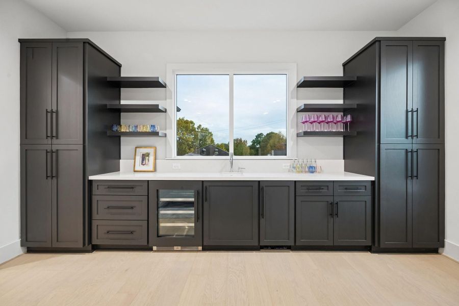 Wet-Bar with Built-In Cabinets, Drawers and Floating Shelves.  There is also a Slab Quartz Counter, Undermount Sink, Ice Maker, and a Beverage Center.