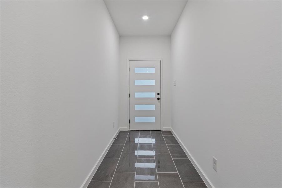 Entryway featuring dark tile patterned floors