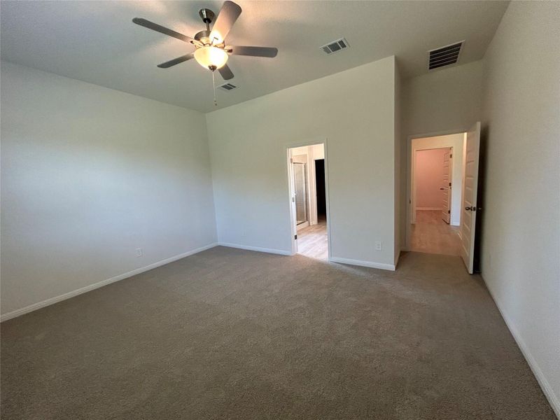 Unfurnished bedroom featuring ceiling fan and carpet Unfurnished bedroom featuring ceiling fan and carpet