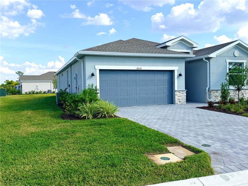 Front exterior of a new home in Island Lakes at Coco Bay: Executive Homes, Englewood, FL, highlighting curb appeal (Image 8).