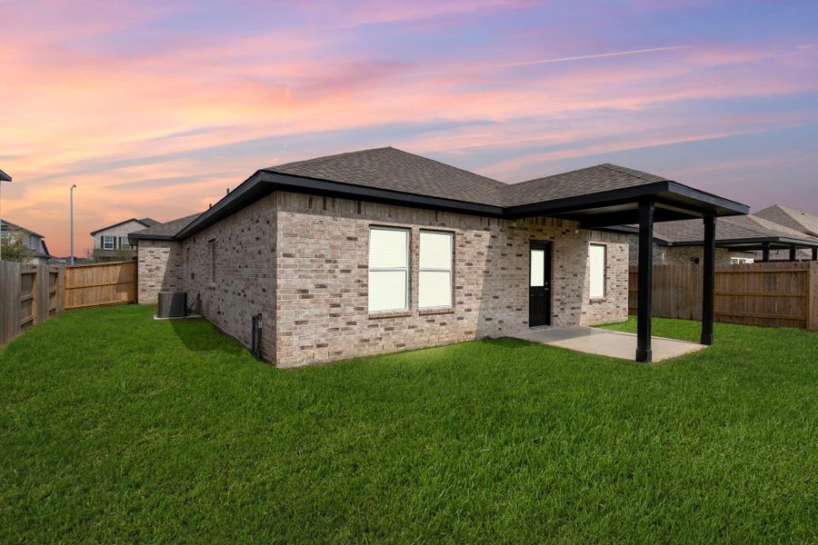 Serene backyard at sunset! The covered patio glows softly against the colorful evening sky, offering the perfect place to unwind after a busy day. Whether hosting a quiet dinner or enjoying the calm of twilight, this outdoor retreat is pure perfection.