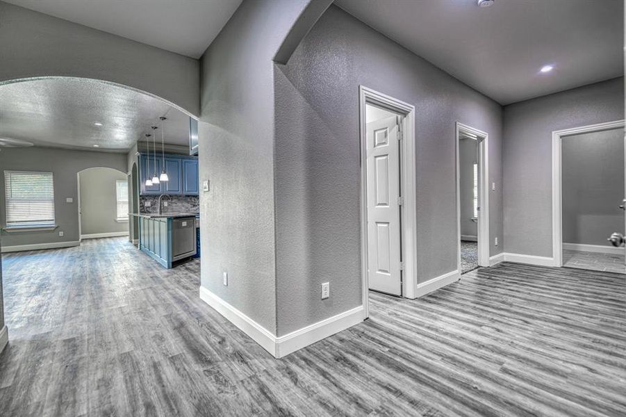 Unfurnished living room featuring sink and hardwood / wood-style floors