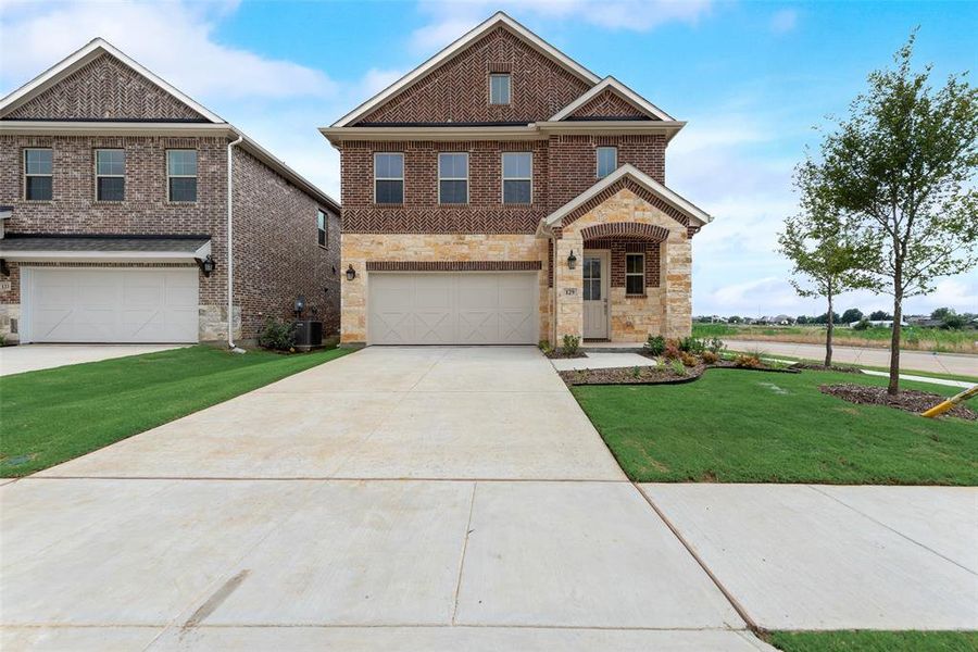 Front exterior of a new home in Spiritas Ranch, Little Elm, TX, highlighting curb appeal (Image 17).