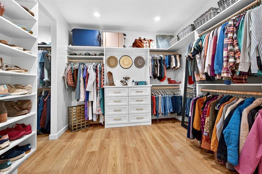Walk in closet featuring light wood-style floors Walk in closet featuring light wood-style floors