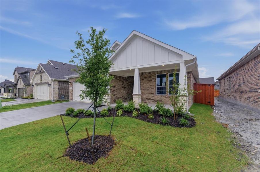 Single-story residence featuring a brick and stone exterior with white board-and-batten gables