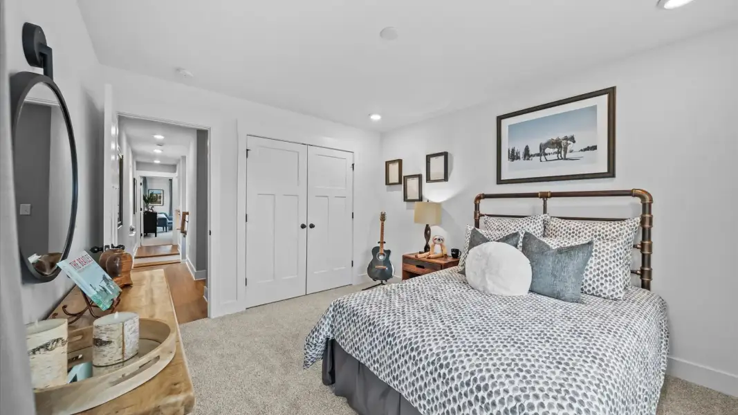 Highly functional bedroom with walk-in closet and tasteful carpet for a restful retreat Highly functional bedroom with walk-in closet and tasteful carpet for a restful retreat