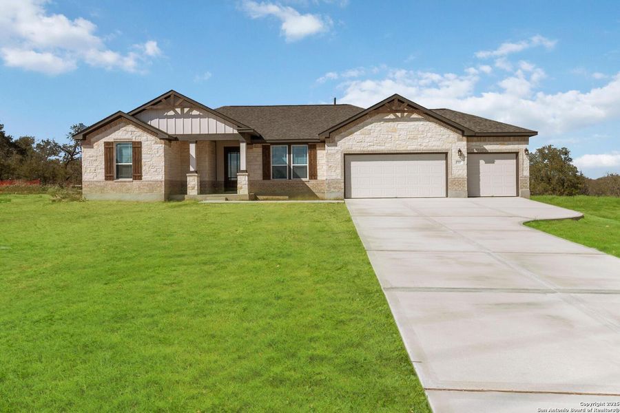 Front exterior of a new home in Jordan's Ranch, San Antonio, TX, highlighting curb appeal (Image 2).