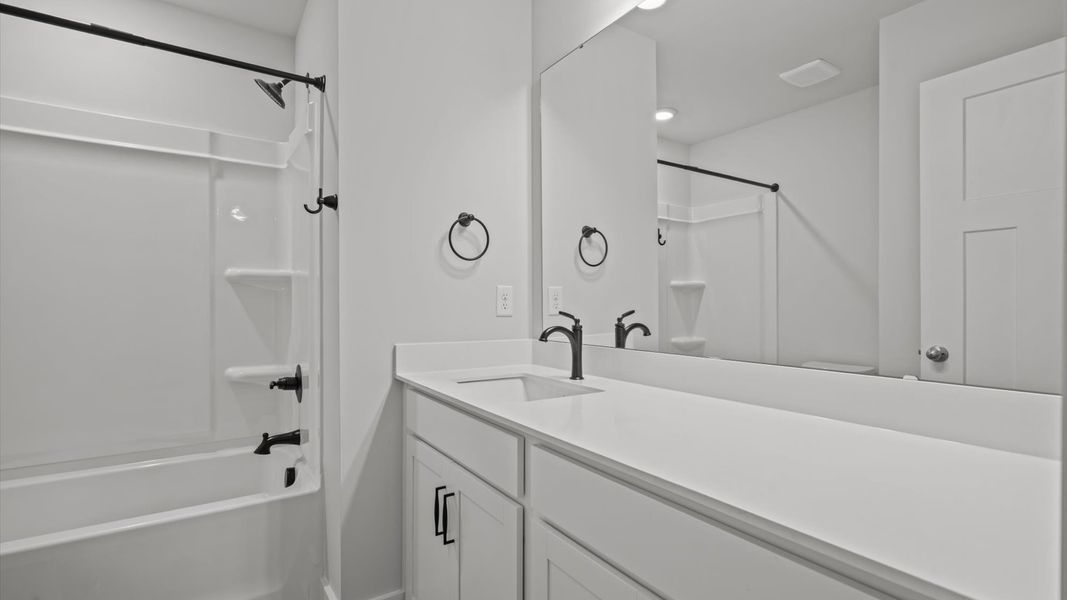 First-rate full bath featuring modern surfaces and a fresh, current color palette First-rate full bath featuring modern surfaces and a fresh, current color palette