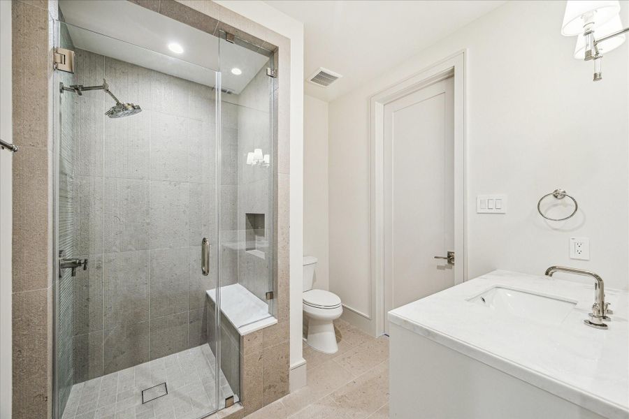 The fourth floor bathroom has direct access to both the bedroom / theater and the hallway. Here the tile is Lith Antique Creme matte porcelain tile with Potters Bar Agave vertical accent wall. The fourth floor bathroom has direct access to both the bedroom / theater and the hallway. Here the tile is Lith Antique Creme matte porcelain tile with Potters Bar Agave vertical accent wall.