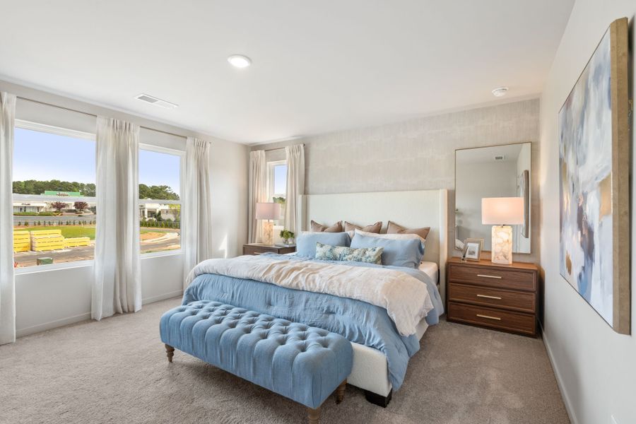 A bedroom with a large window. A bedroom with a large window.