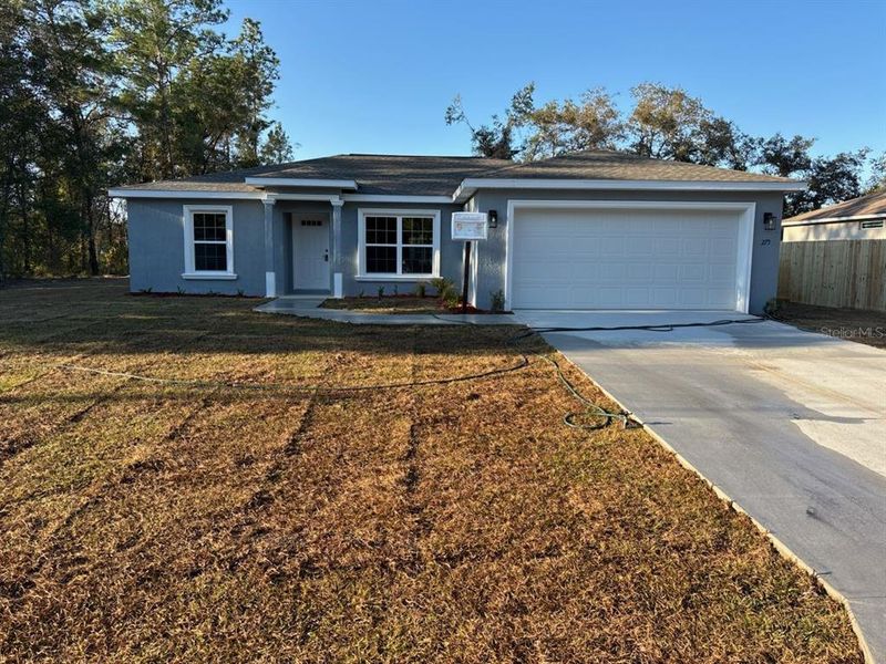 Front exterior of a new home in , Citrus Springs, FL, highlighting curb appeal (Image 1).