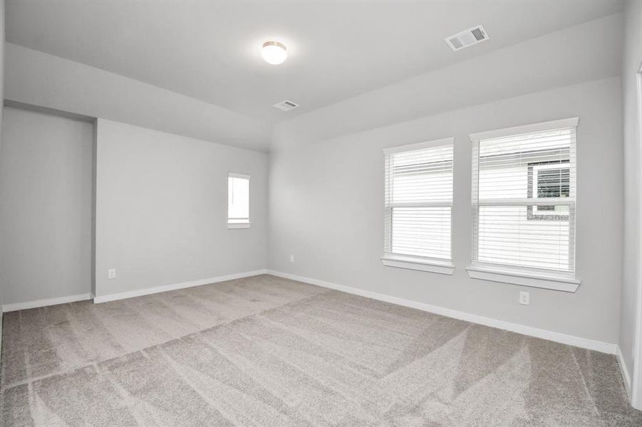 Come upstairs and enjoy a day of leisure in this fabulous game room! This is the perfect hangout spot or adult game room! Features plush carpet, high ceilings, custom paint and windows for plenty of natural light. Sample photo of completed home with similar floor plan. Actual colors and selections may vary.