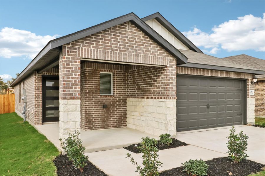 View of front of property featuring brick siding, a garage, board and batten siding, and concrete driveway View of front of property featuring brick siding, a garage, board and batten siding, and concrete driveway
