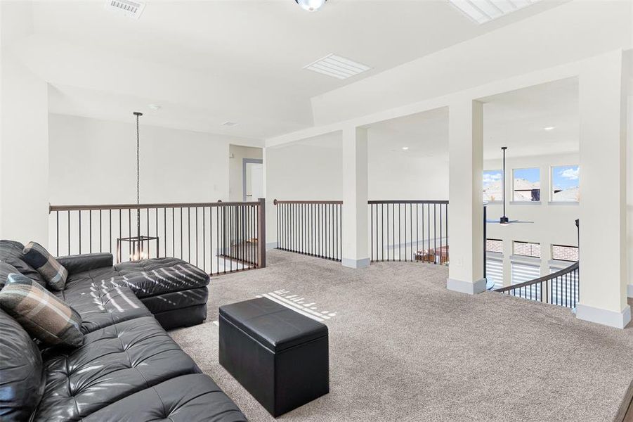 Living area with carpet and a ceiling fan Living area with carpet and a ceiling fan