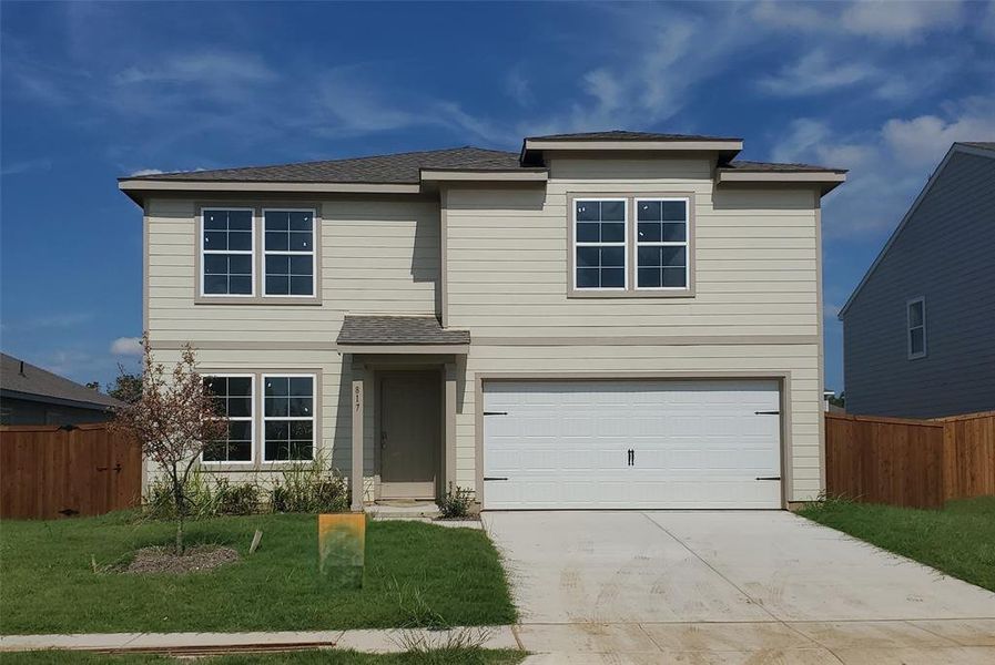 View of front of house with a garage and a front lawn