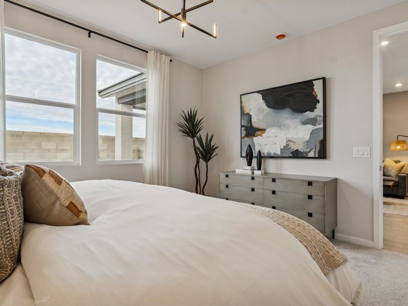 A bedroom with a large window.