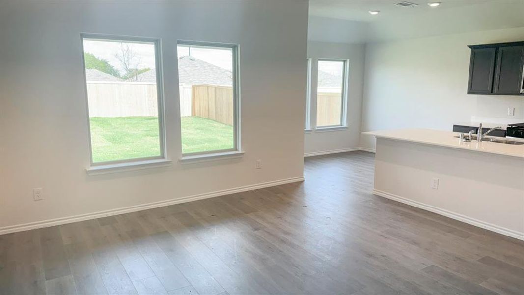 Unfurnished dining area with dark wood finished floors and recessed lighting
