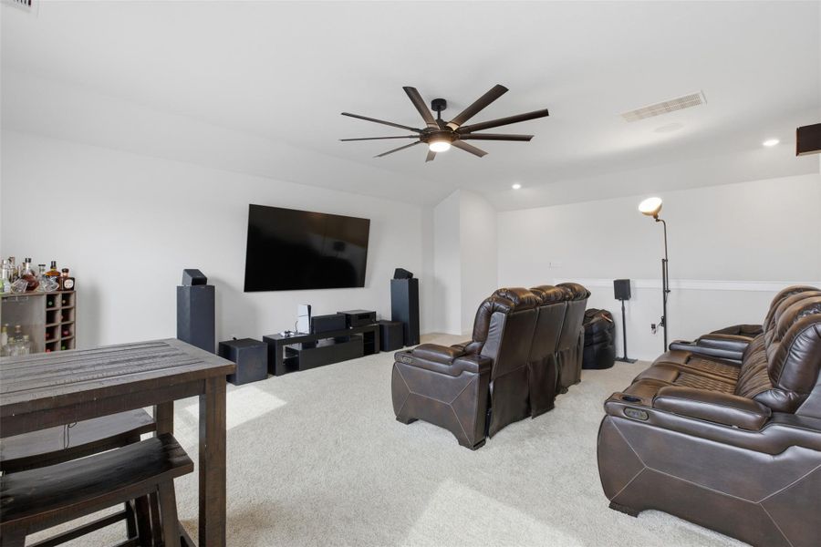 Living room featuring light carpet, a ceiling fan, and recessed lighting