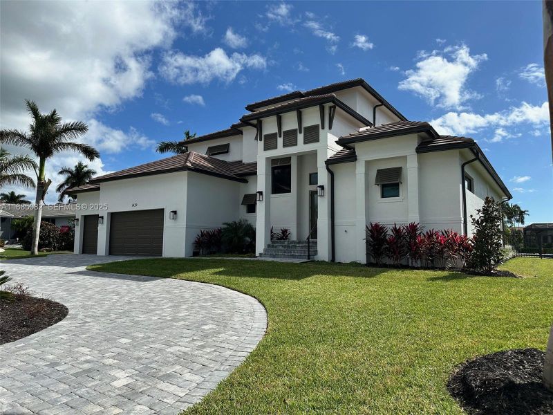 Front exterior of a new home in , Marco Island, FL, highlighting curb appeal (Image 1). Front exterior of a new home in , Marco Island, FL, highlighting curb appeal (Image 1).