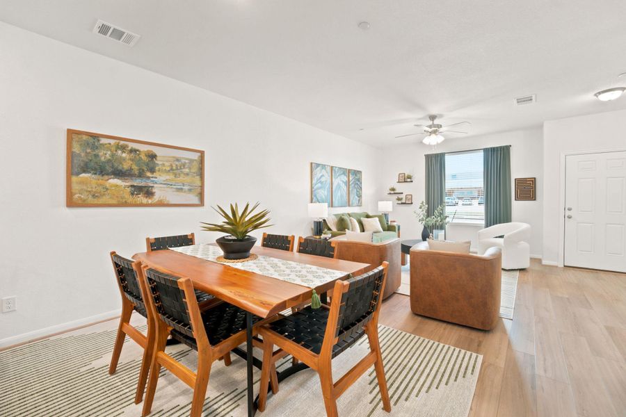An open floor plan seamlessly connects the dining space with the living area.