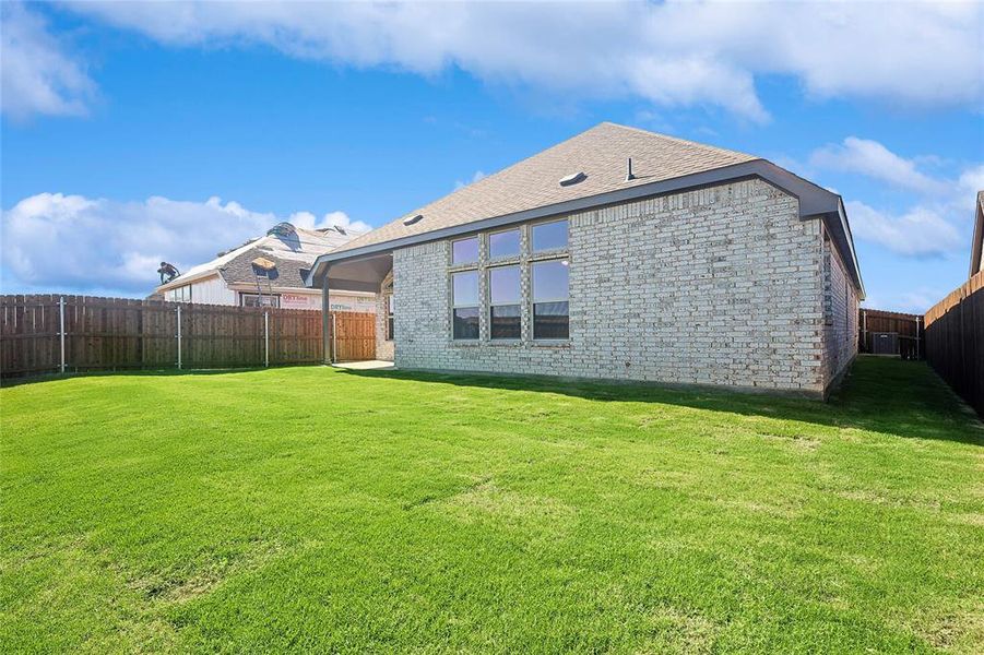 Back of house featuring a lawn