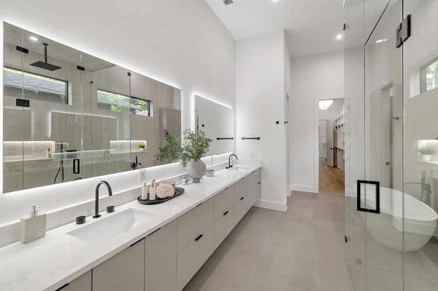Contemporary bathroom featuring an expansive dual vanity with integrated sinks and matte black fixtures