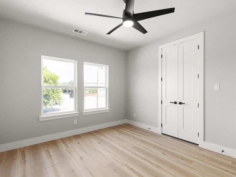 Light wood-finish flooring complemented by light gray wall paint Light wood-finish flooring complemented by light gray wall paint