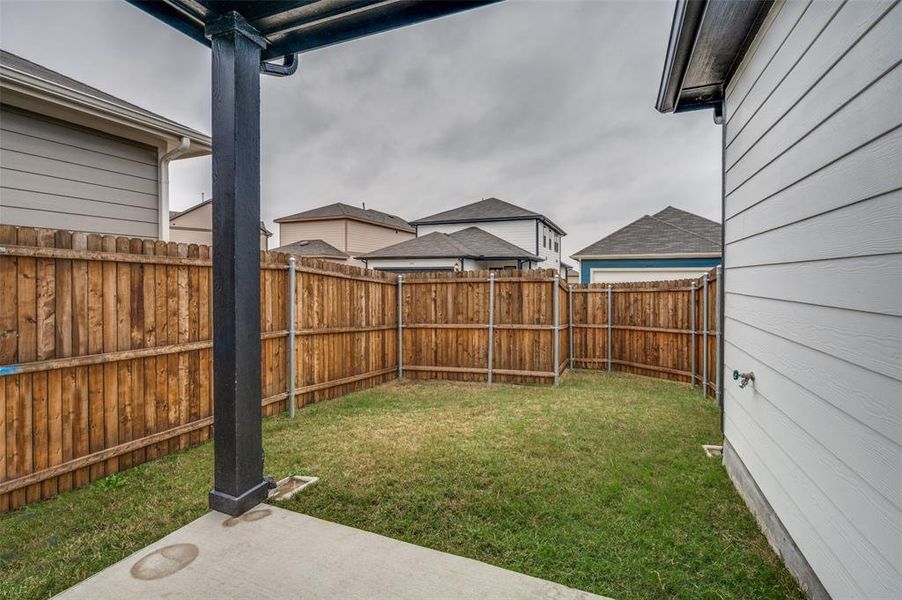 Fenced backyard featuring a patio