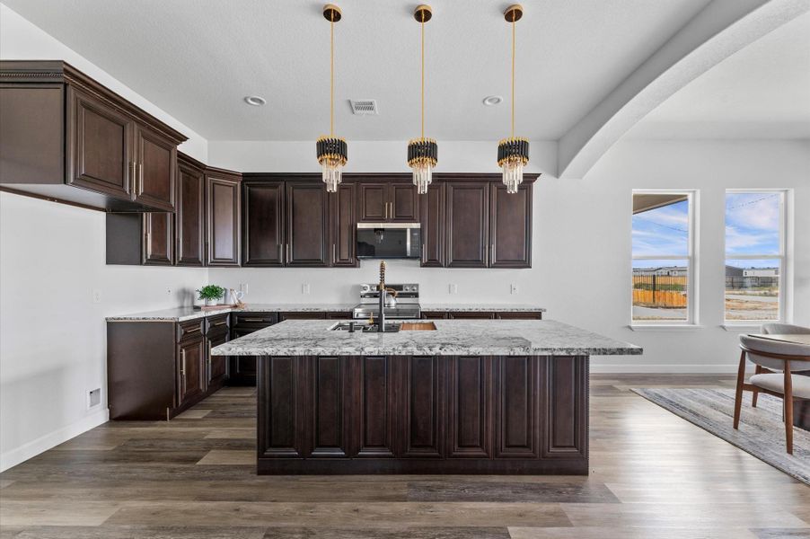 Chef’s kitchen featuring 60" custom cabinetry to the ceiling, granite countertops, stainless steel appliances, and a large prep-friendly layout. Chef’s kitchen featuring 60" custom cabinetry to the ceiling, granite countertops, stainless steel appliances, and a large prep-friendly layout.