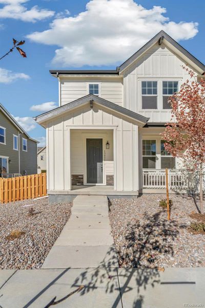 Front exterior of a new home in Turnberry Villas, Commerce City, CO, highlighting curb appeal (Image 1).