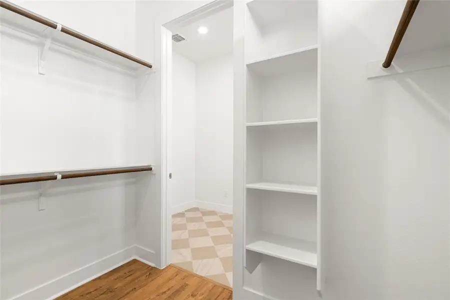 A well-organized closet offers ample storage with integrated shelving and hanging rods. A well-organized closet offers ample storage with integrated shelving and hanging rods.