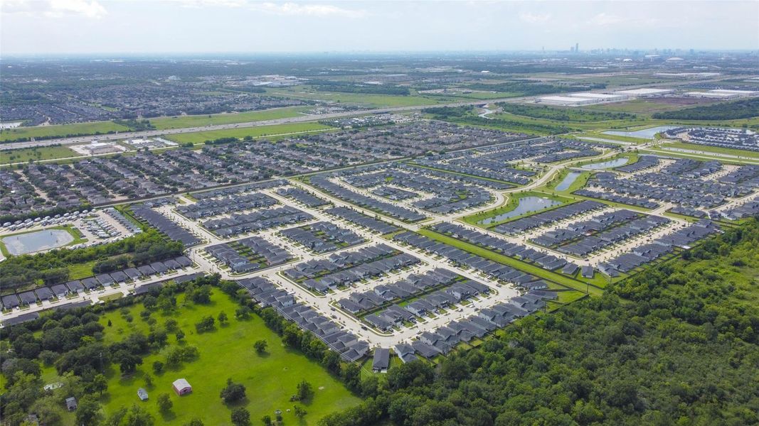 Stretching across acres of suburban planning, this aerial shot captures the scale and layout of a thriving master-planned community. Tree-lined borders, walking paths, and scenic water features are all visible, illustrating a neighborhood built for lifestyle and longevity. Stretching across acres of suburban planning, this aerial shot captures the scale and layout of a thriving master-planned community. Tree-lined borders, walking paths, and scenic water features are all visible, illustrating a neighborhood built for lifestyle and longevity.