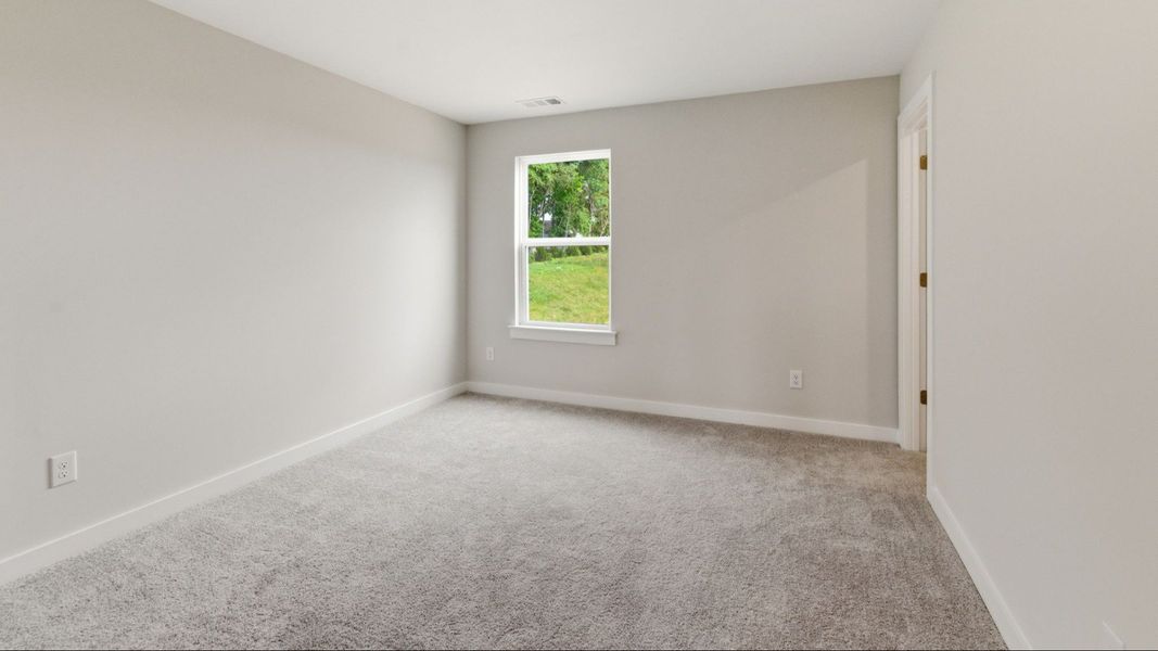 Bedroom with carpet and windows
