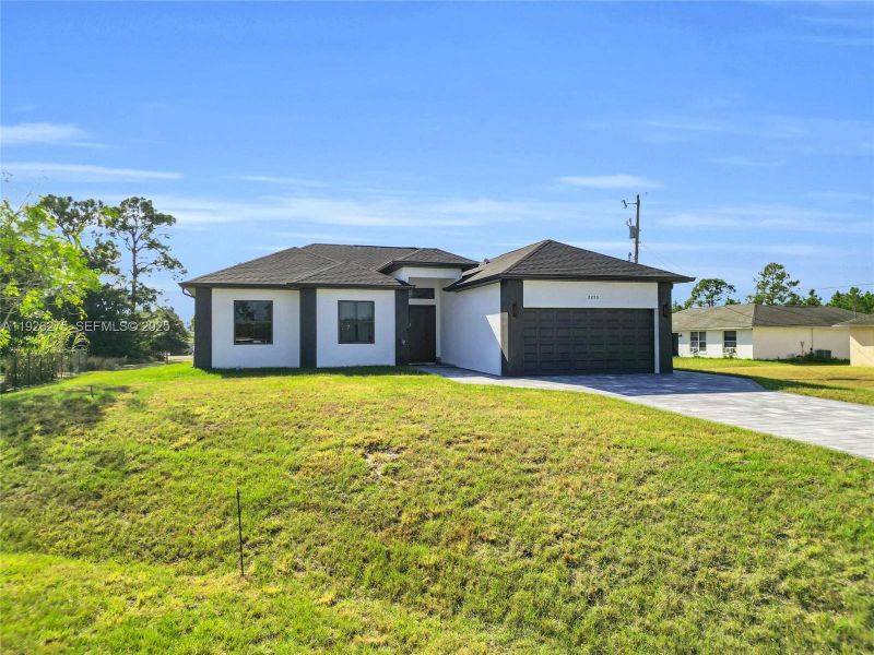 Front exterior of a new home in , Lehigh Acres, FL, highlighting curb appeal (Image 23).