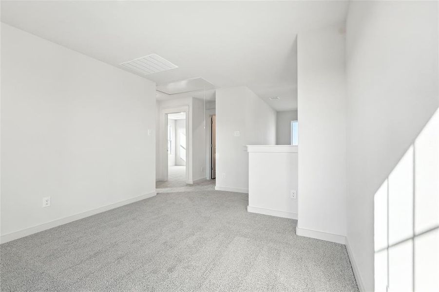 Spare room featuring carpet floors and attic access Spare room featuring carpet floors and attic access
