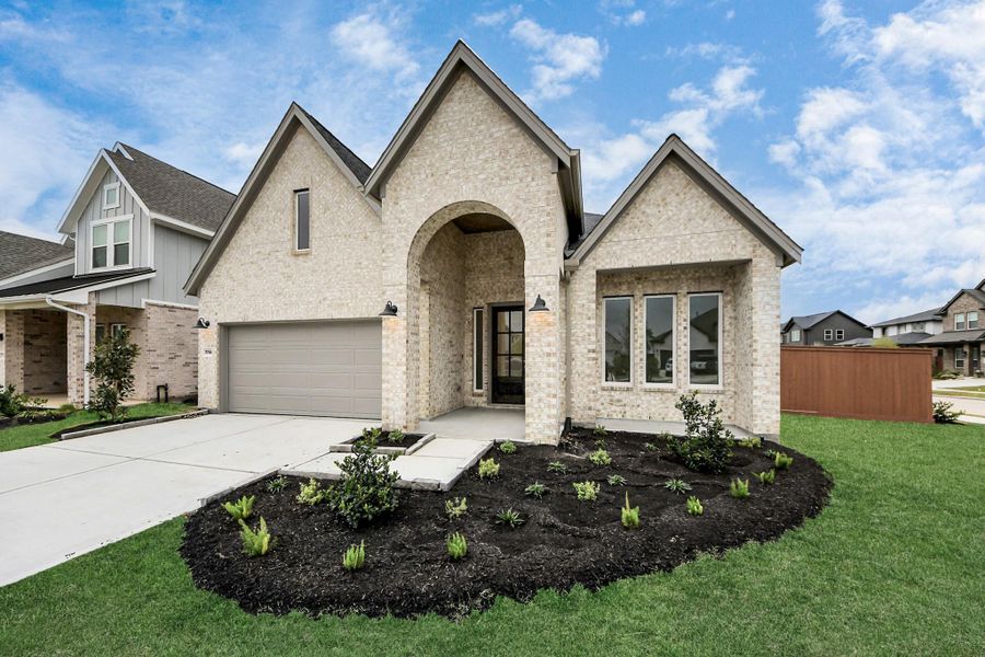 Front exterior of a new home in 50' Traditional Homes at Elyson, Katy, TX, highlighting curb appeal (Image 2). Front exterior of a new home in 50' Traditional Homes at Elyson, Katy, TX, highlighting curb appeal (Image 2).