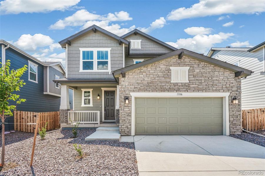 Front exterior of a new home in Turnberry, Commerce City, CO, highlighting curb appeal (Image 1).