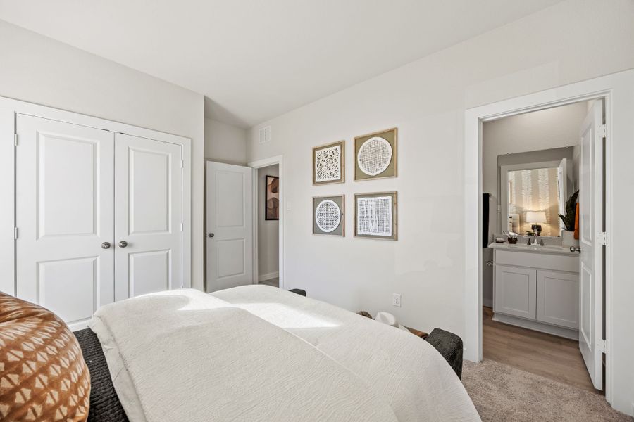 A bedroom with a bed and a mirror. A bedroom with a bed and a mirror.