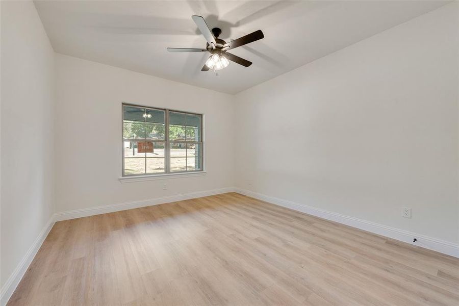 Empty room featuring light hardwood / wood-style flooring and ceiling fan