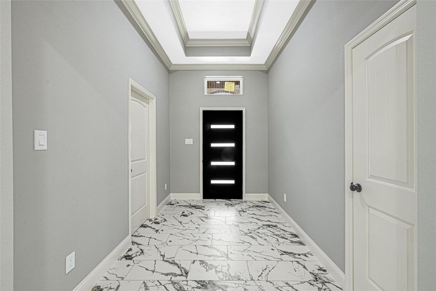 Step inside this inviting foyer, featuring 10 ft. ceilings that show case tray ceilings. Foyer leads to your home office/study to your left. Step inside this inviting foyer, featuring 10 ft. ceilings that show case tray ceilings. Foyer leads to your home office/study to your left.