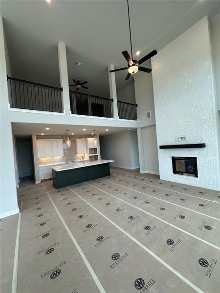 From Family Room with soaring ceiling & fireplace to Open Concept Kitchen From Family Room with soaring ceiling & fireplace to Open Concept Kitchen