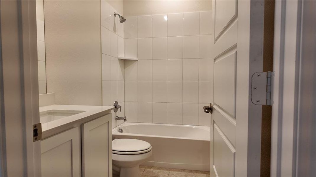 Full bathroom featuring vanity, shower / washtub combination, and tile patterned floors